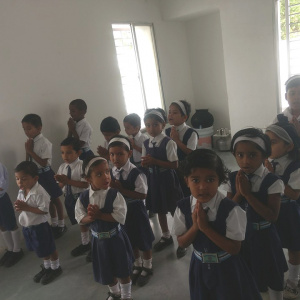 Students reciting their morning prayers in the Urygen Sangharakshita International School