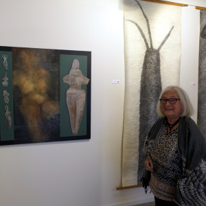 Anne Munz with her paintings and drawings