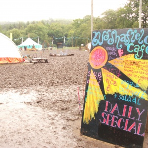 Buddhafield cafe sign and mud at Buddhafield Festival 2012